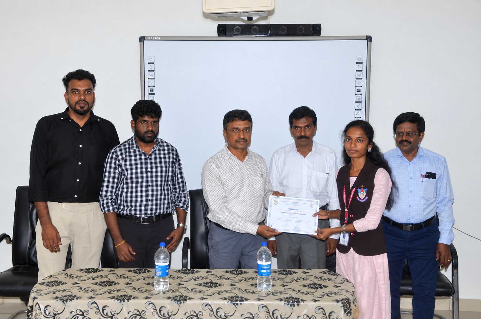 A student receives her certificate of participation at the close of the workshop, with faculty of the Department of Physics and the resource persons from Geospatial Campus
