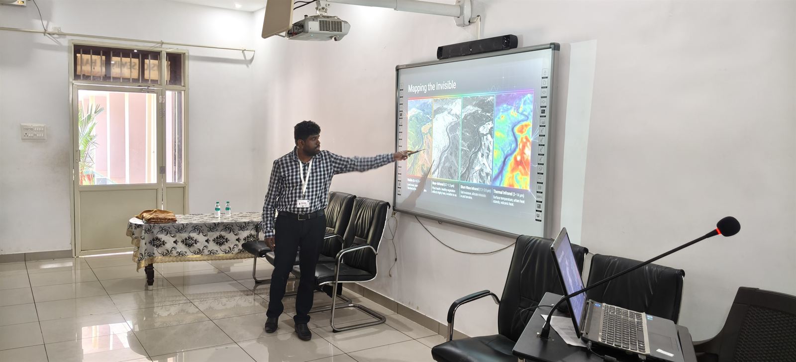 Dr. Aran Castro presenting satellite and thermal imagery during a remote sensing talk